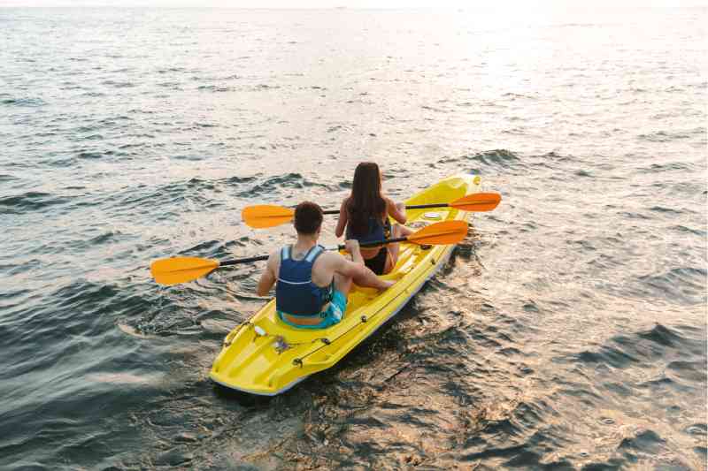 Couple kayaking in the middle of the sea