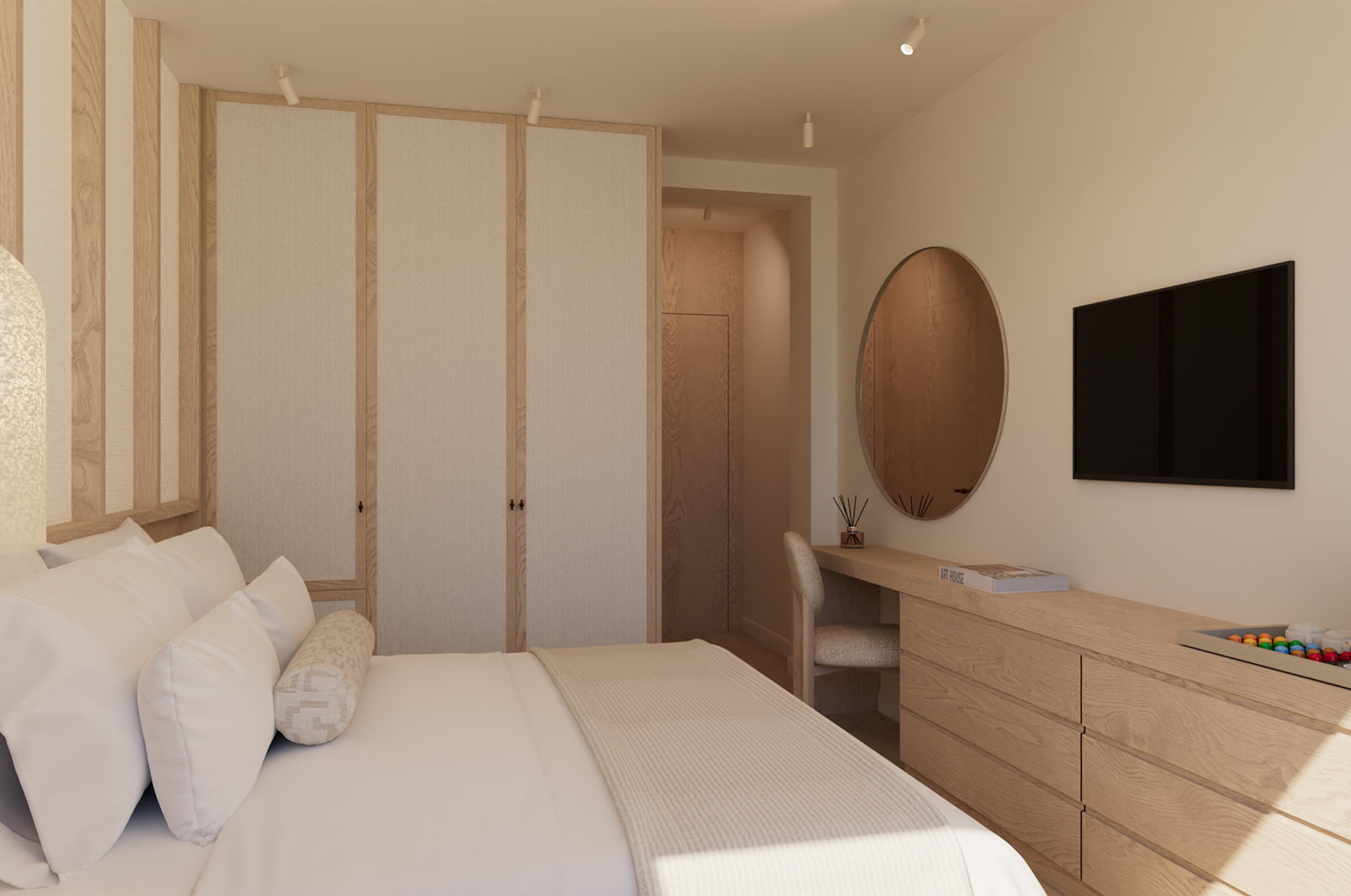 Vista habitación Escritorio con espejo redondo y televisor frente a la cama