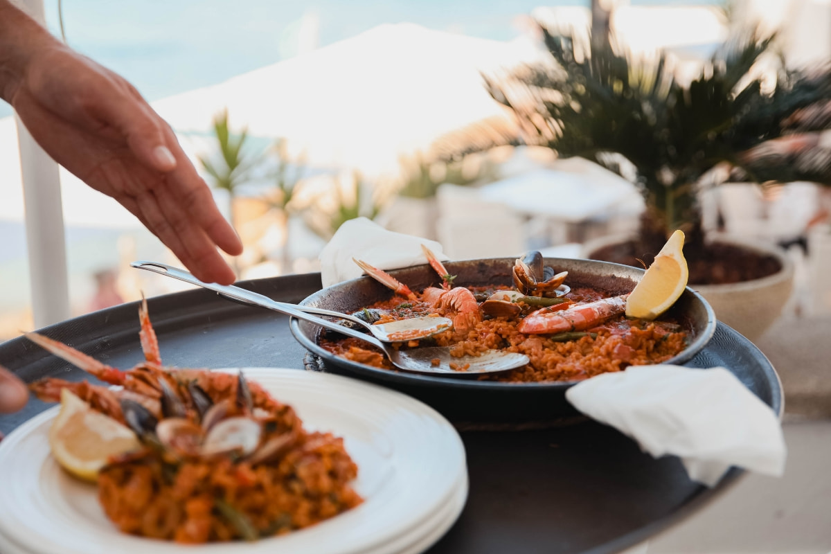 Paella in front of the sea in one of the Hoposa Restaurants